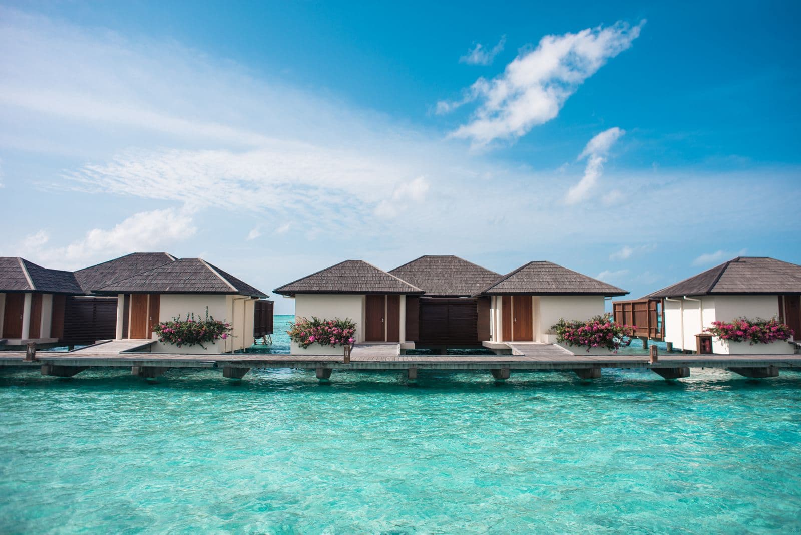 Overwater villas on a pale turquoise lagoon