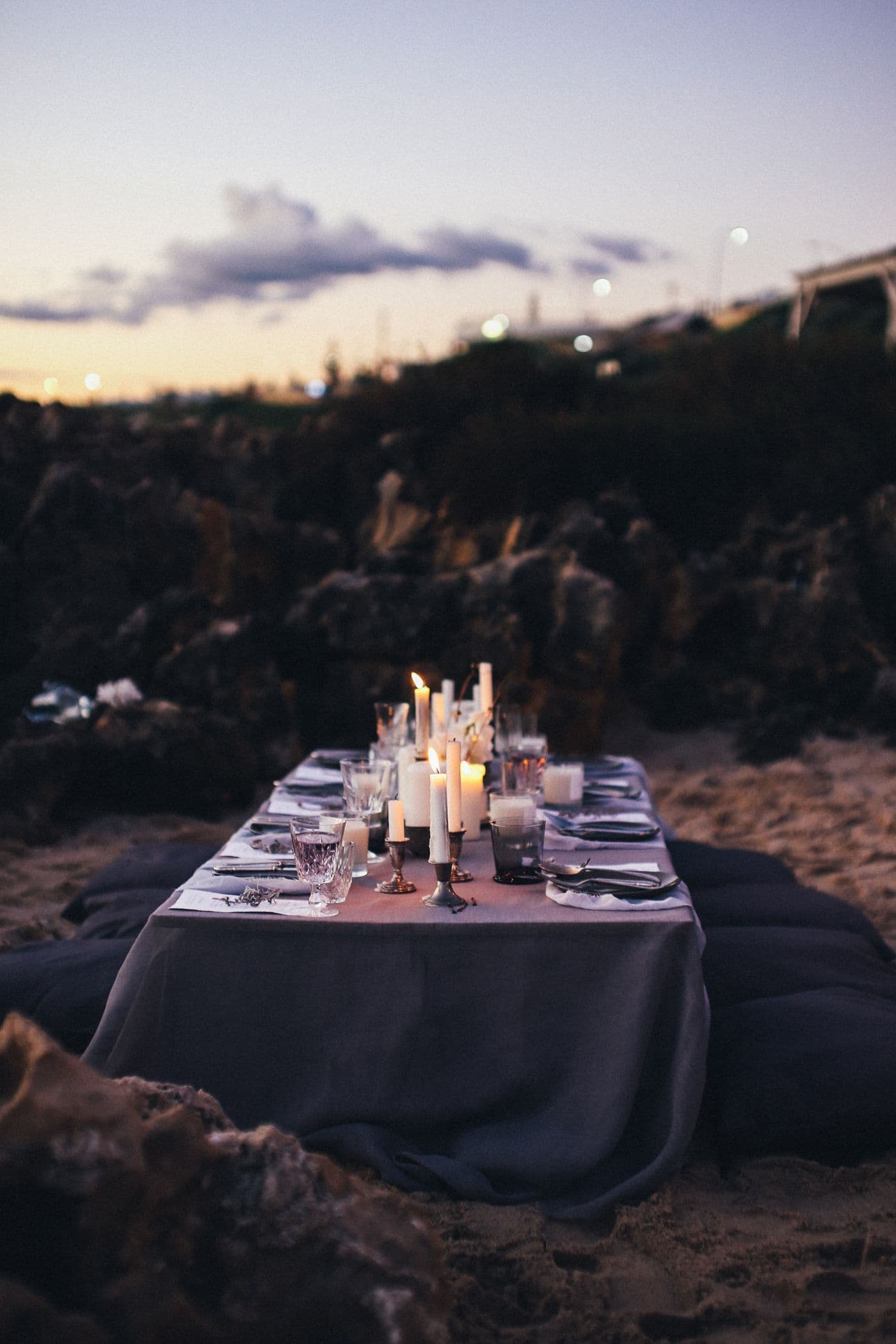 A candlelit table laid on a private terrace