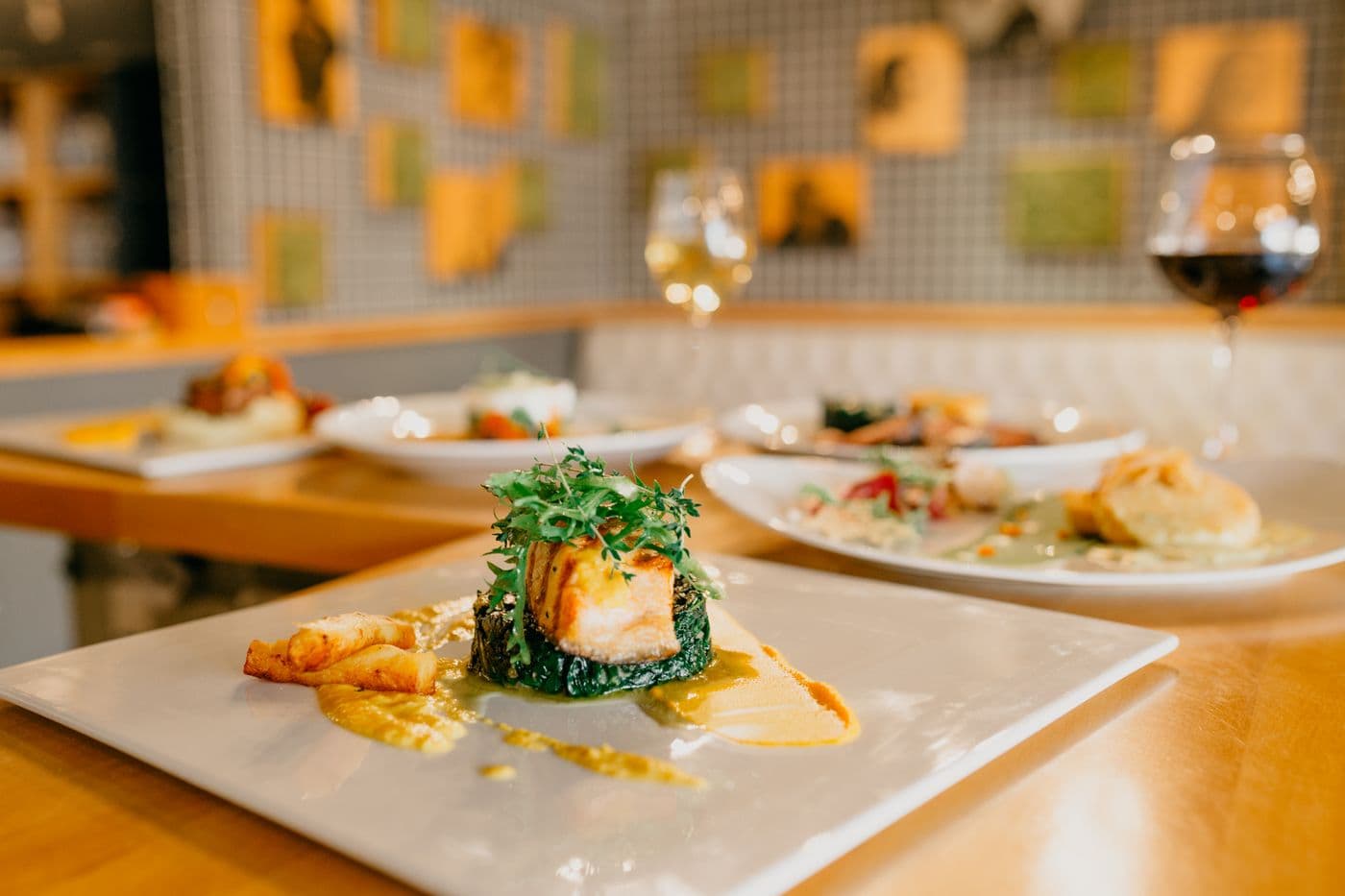 A chef's table set beside an open kitchen