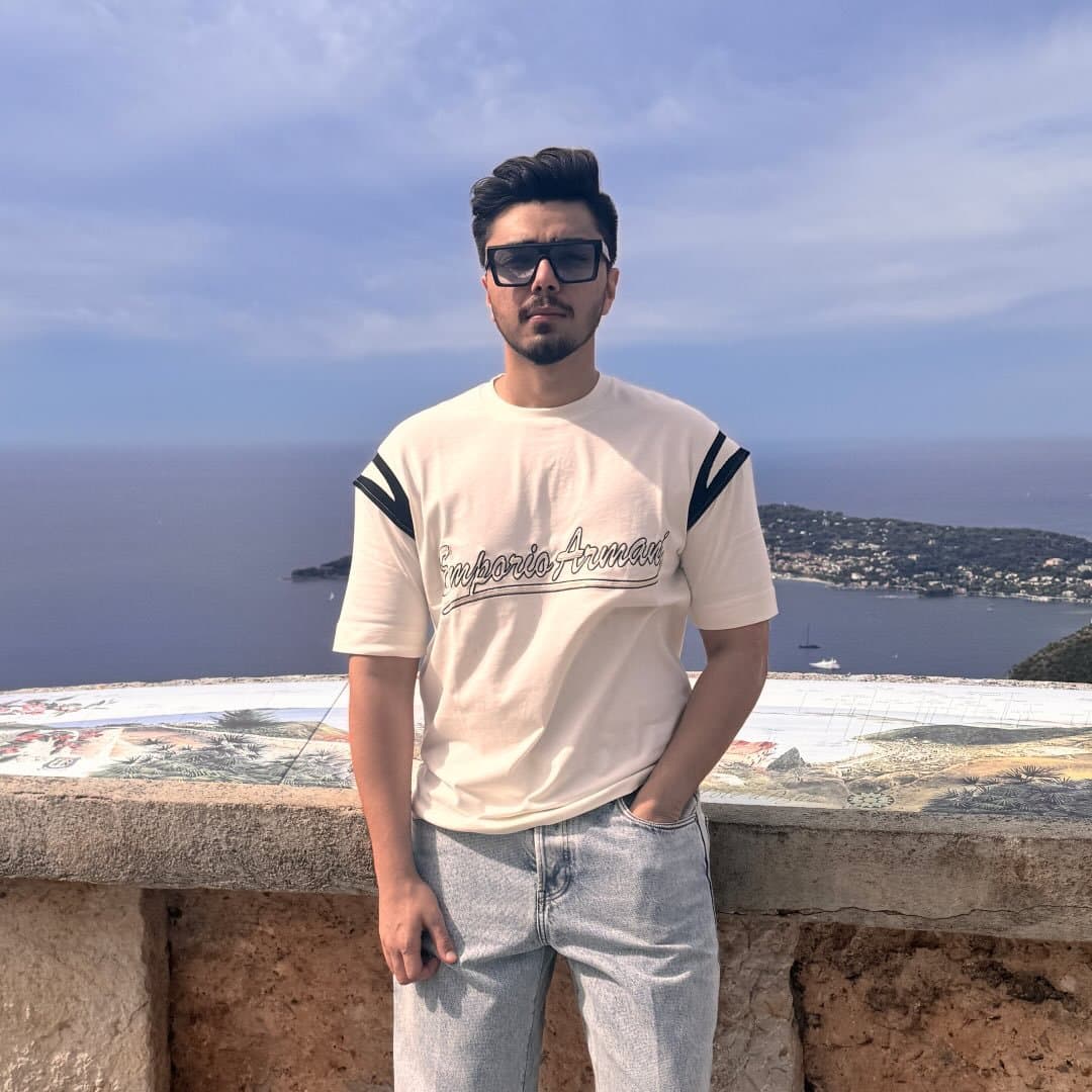 Dev Sodha, founder of Travel Den, above a Mediterranean bay