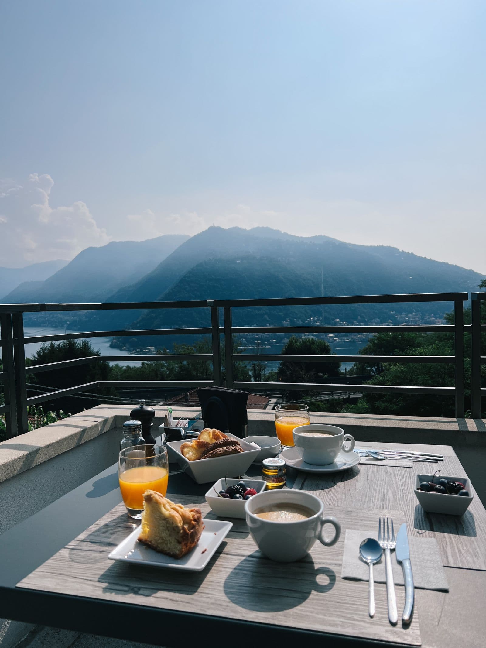 A table laid for breakfast on a terrace above the sea