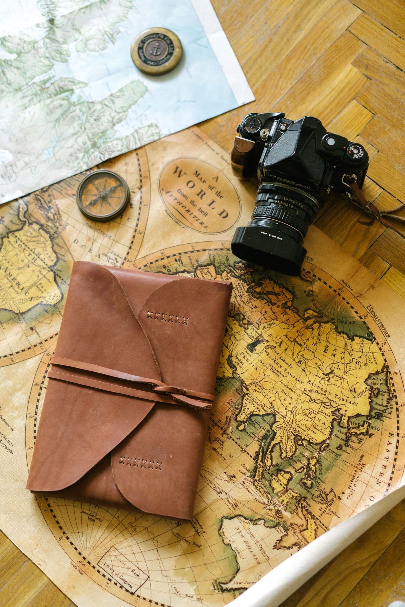 Notes and a map spread across a warm-lit table